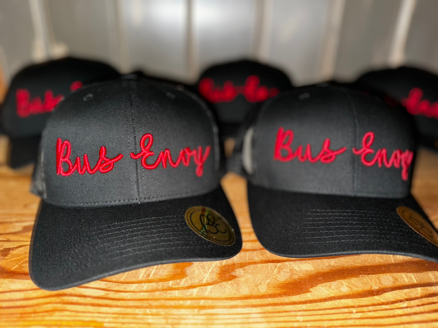 Snap Back Trucker Cap. All Black. Red 3D logo.