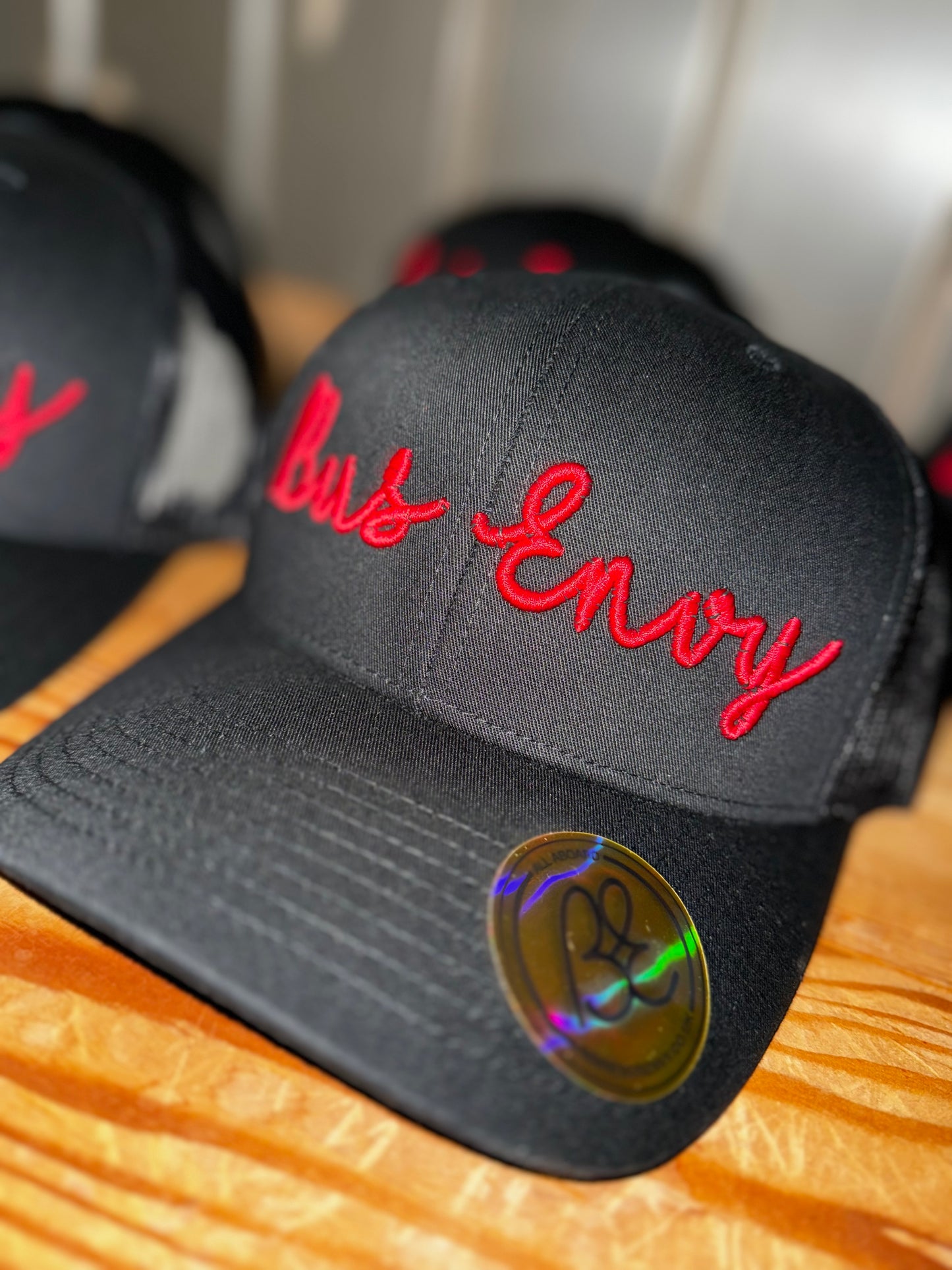 Snap Back Trucker Cap. All Black. Red 3D logo.