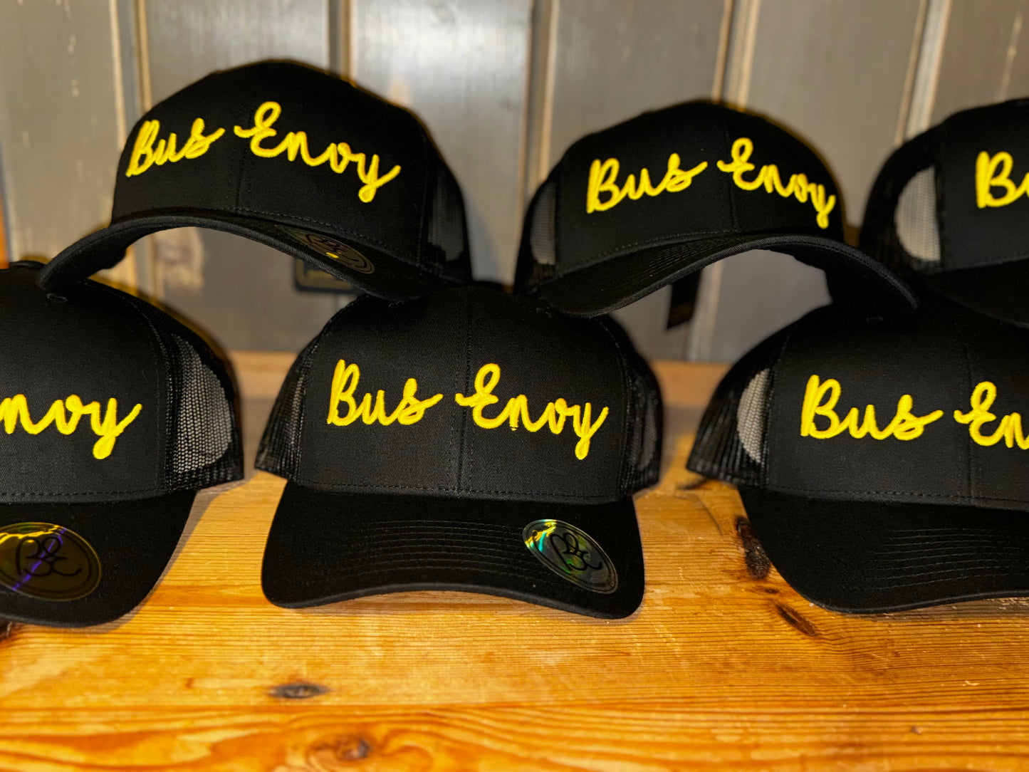 Snap Back Trucker Cap. All black. Yellow 3D logo.