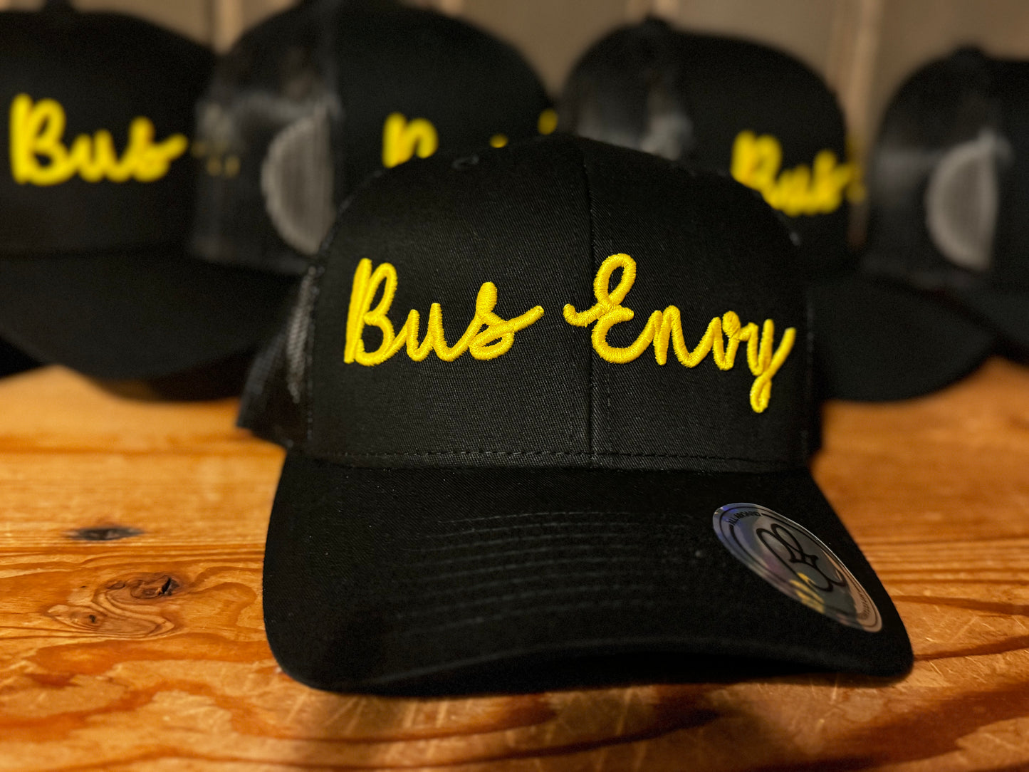 Snap Back Trucker Cap. All black. Yellow 3D logo.