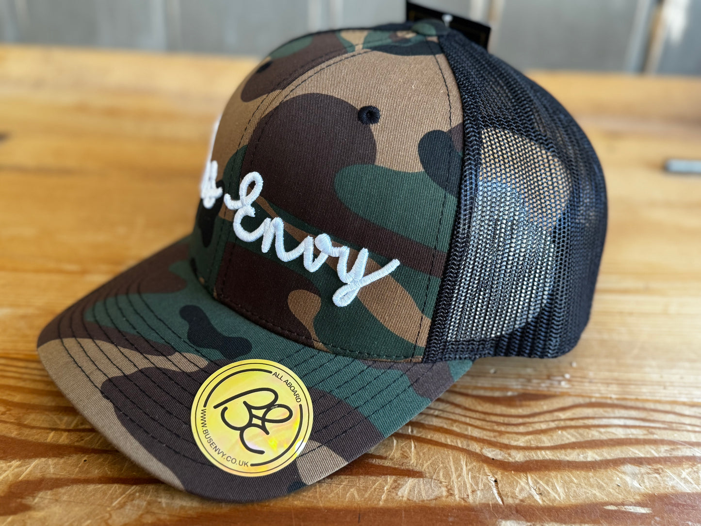 Snap Back Trucker Cap. Cammo & Black. White 3D logo.