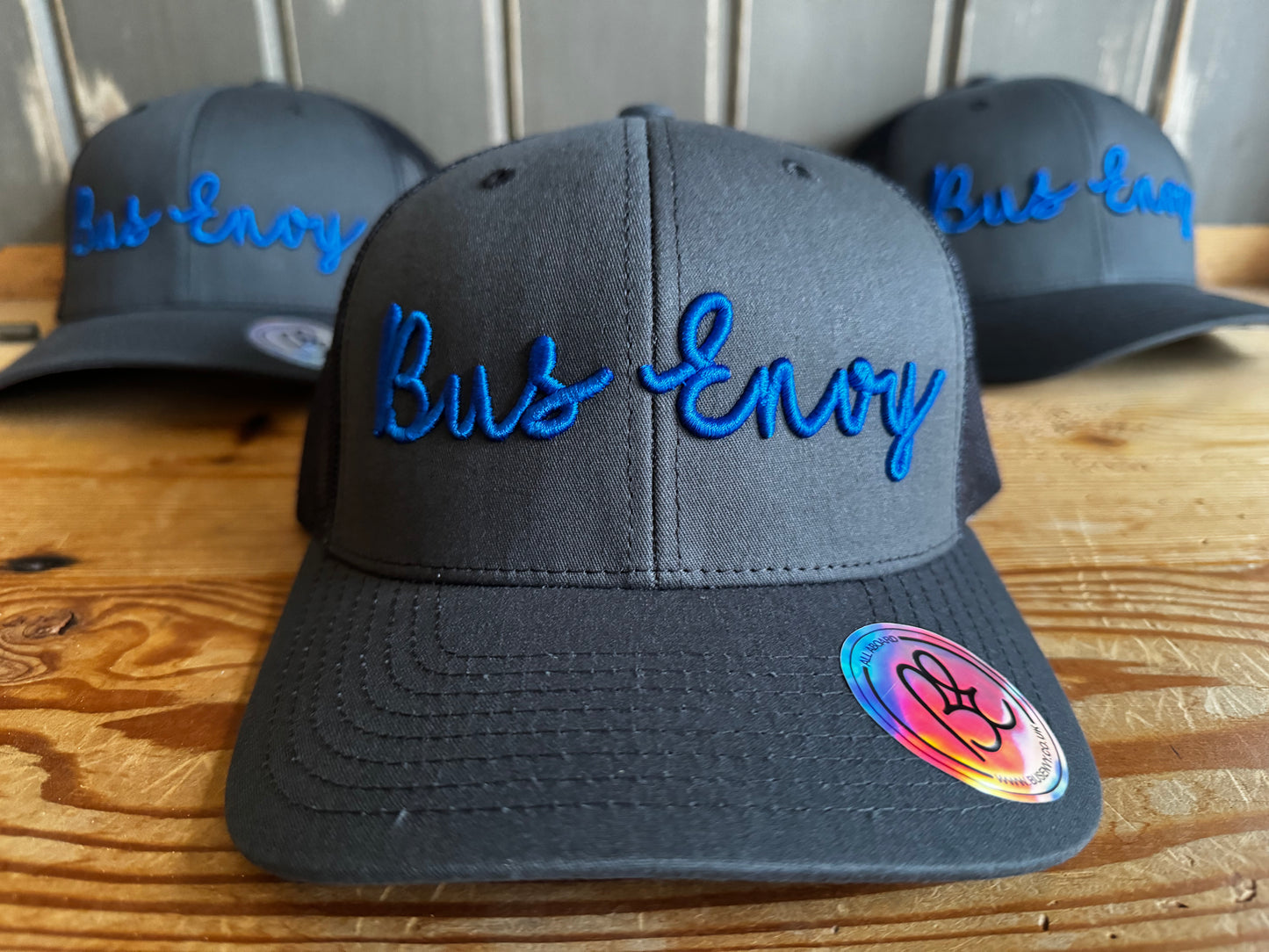 Snap back Trucker Cap. Grey/Blue 3D logo.