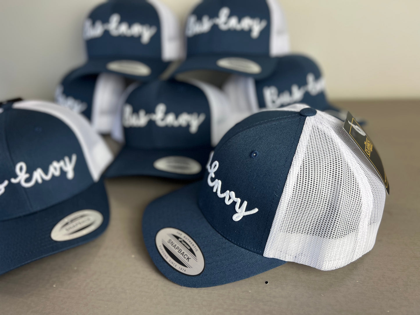 Snap Back Trucker Cap. Navy & White / White 3D logo.